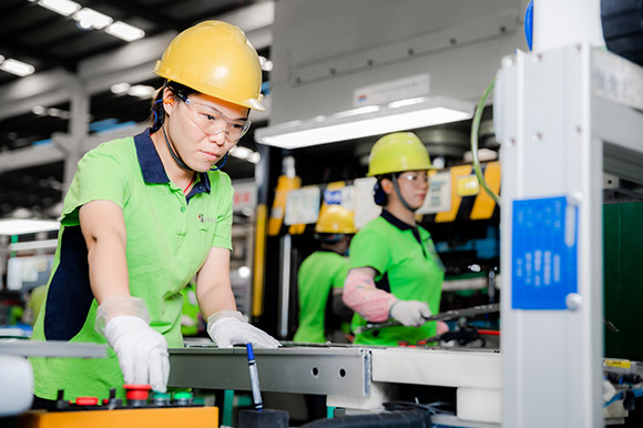 Staff operating production equipment